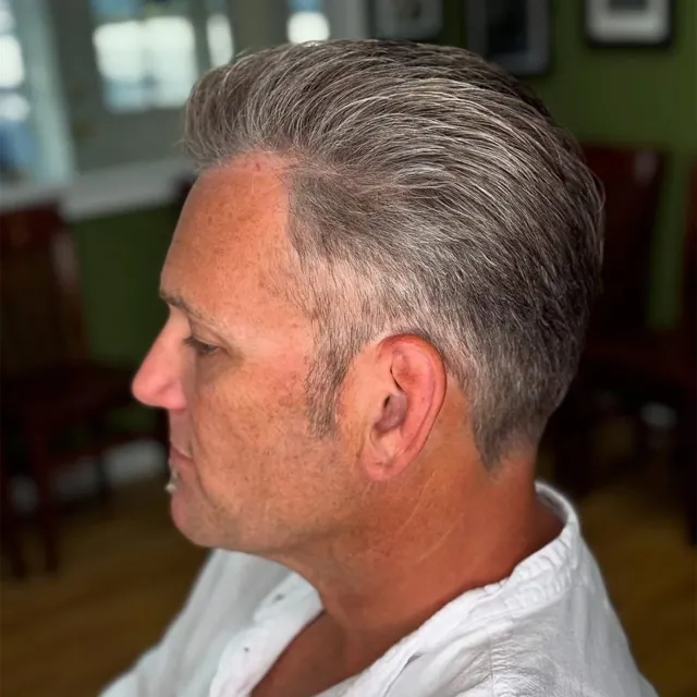 Silver slicked-back cut with a tapered neck.