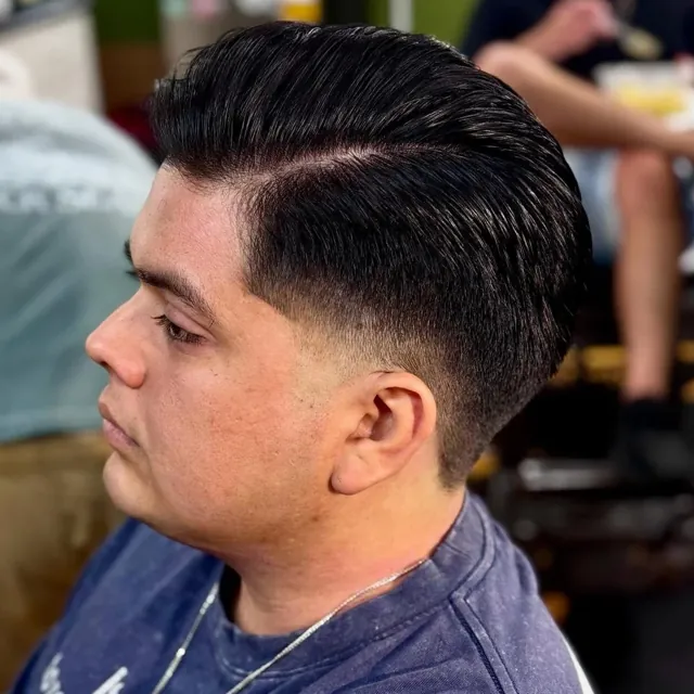 Hard-part pompadour with a skin fade.