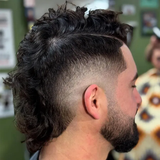 Curly mohawk with a faded side.