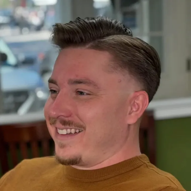 Textured quiff with a mid fade.